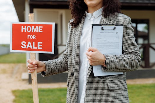 A real estate agent holding a home for sale sign and clipboard outside a property.
